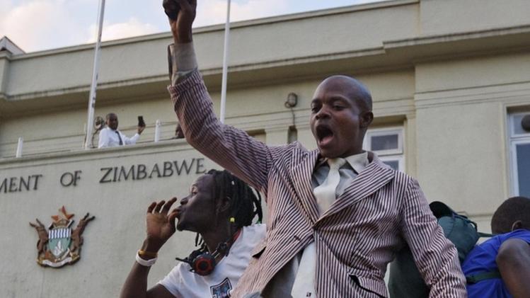 Scene di giubilo davanti al parlamento dopo la deposizione di Mugabe. ANSA/AP PHOTO/BEN CURTIS 